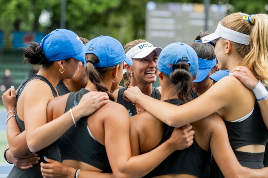 Tennis team huddling together before a match